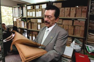 Paraguayan human rights activist Martin Almada inspects documents at the Paraguay's Defense Ministry in Asuncion, Wednesday, Oct. 14, 2009. Documents from the secret archive of the Paraguayan army during the 1954-1989 dictatorship of Gen. Alfredo Stroessner, including some connected to  the so-called Operation Condor, a  plan implemented by South American military dictatorships during the 1970s to eliminate dissidents, were found by human rights activists in a Paraguay's Defense Ministry's basement. (AP Photo/Jorge Saenz)